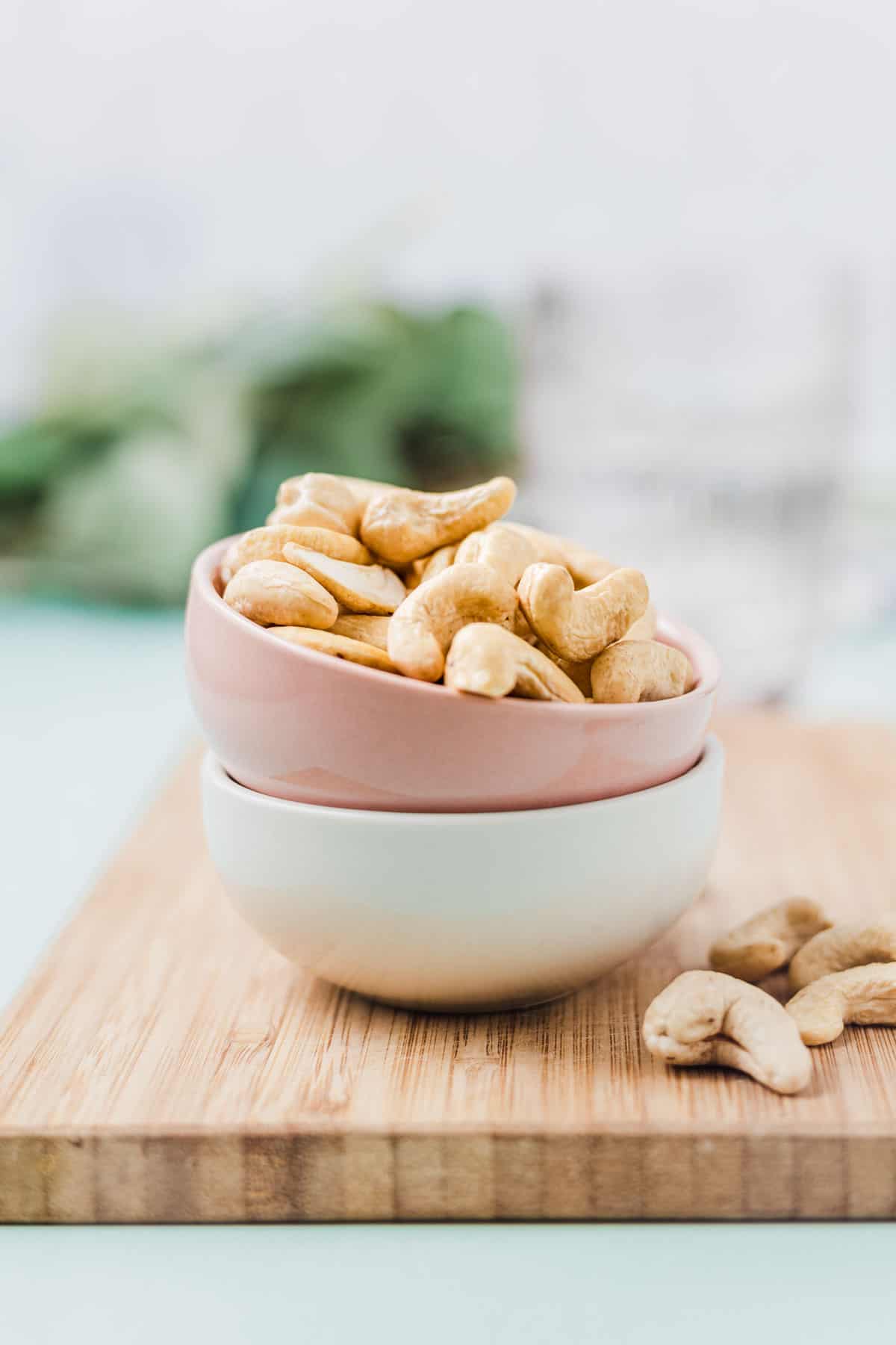 Cashews in a small pink bowl.