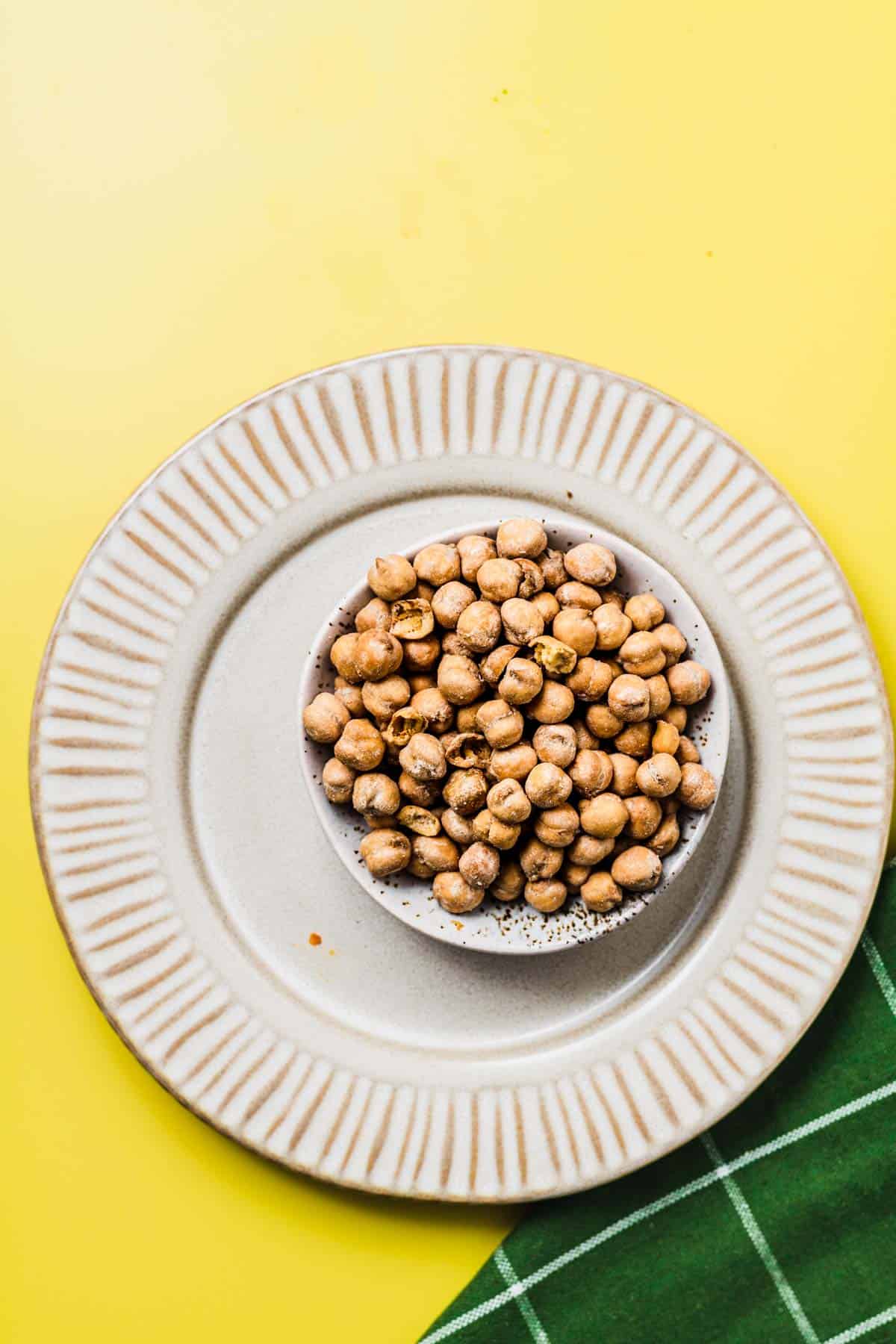 Birds eye view of roasted chickpeas in a white bowl.