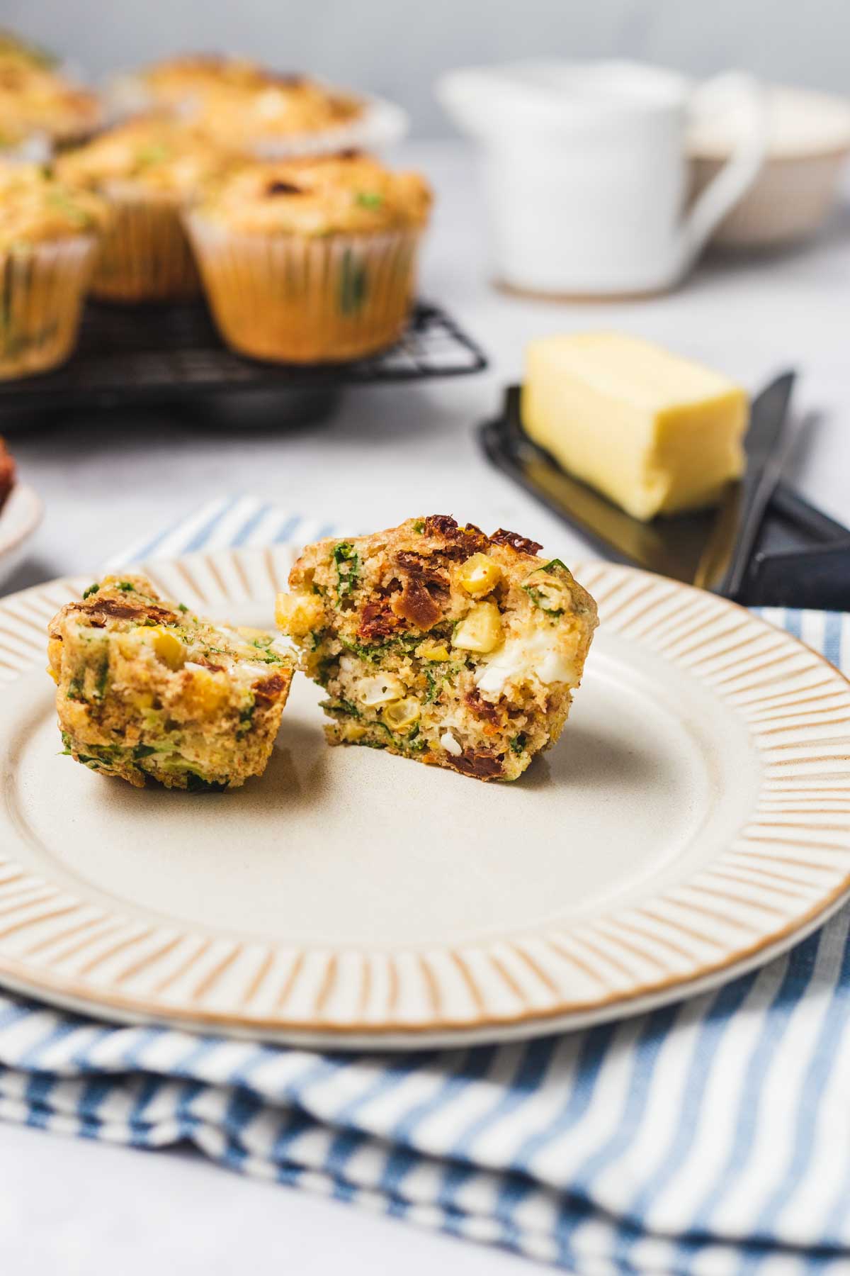 Close up picture of muffins with vegetables and feta.