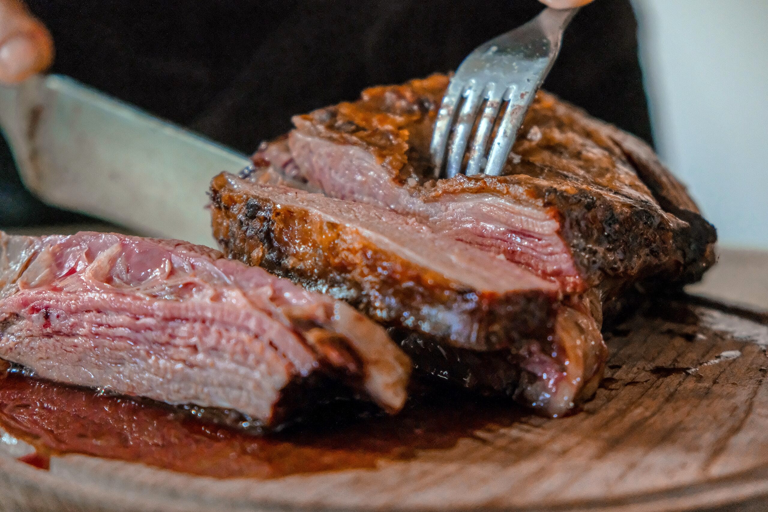 Close up of a steak being cut.