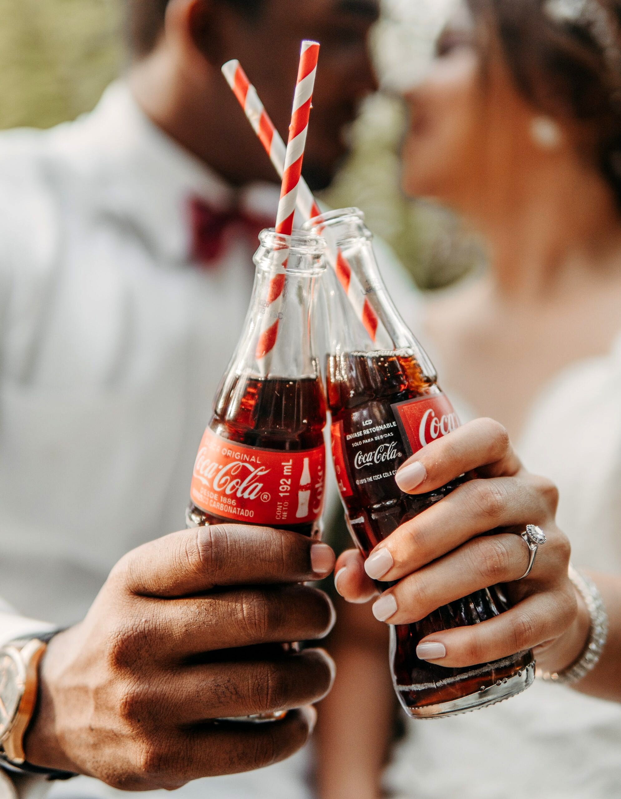 Two glass coke bottles with straws discussing no more bloating.