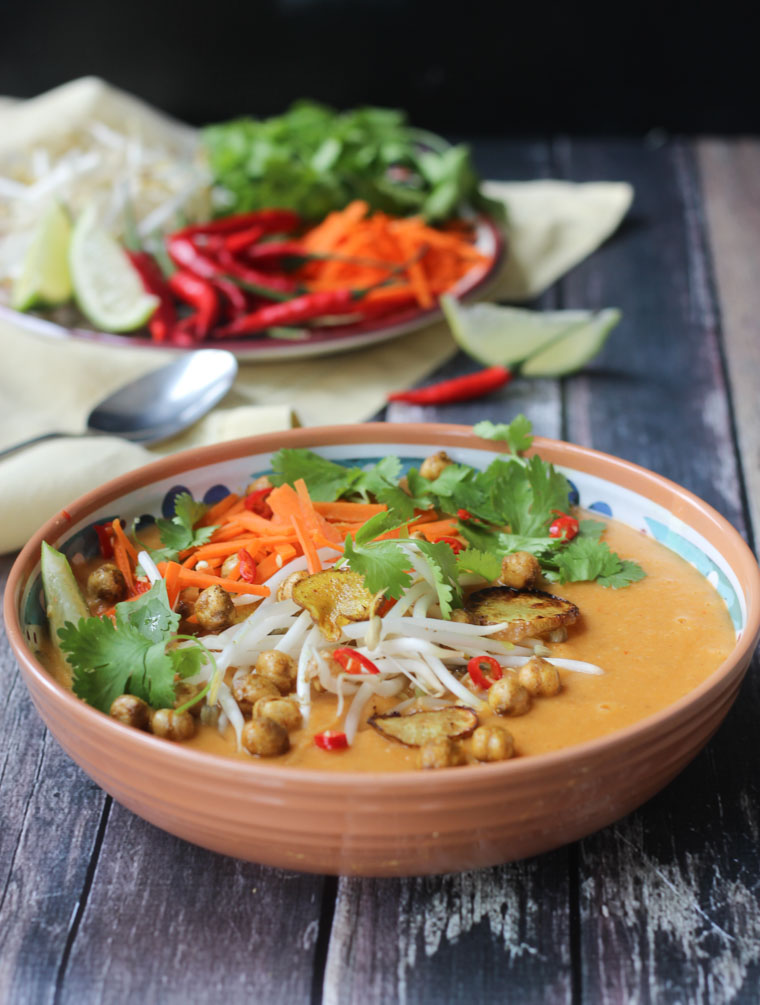 Close up of vegan curry soup with crispy chickpeas and sunchoke chips.