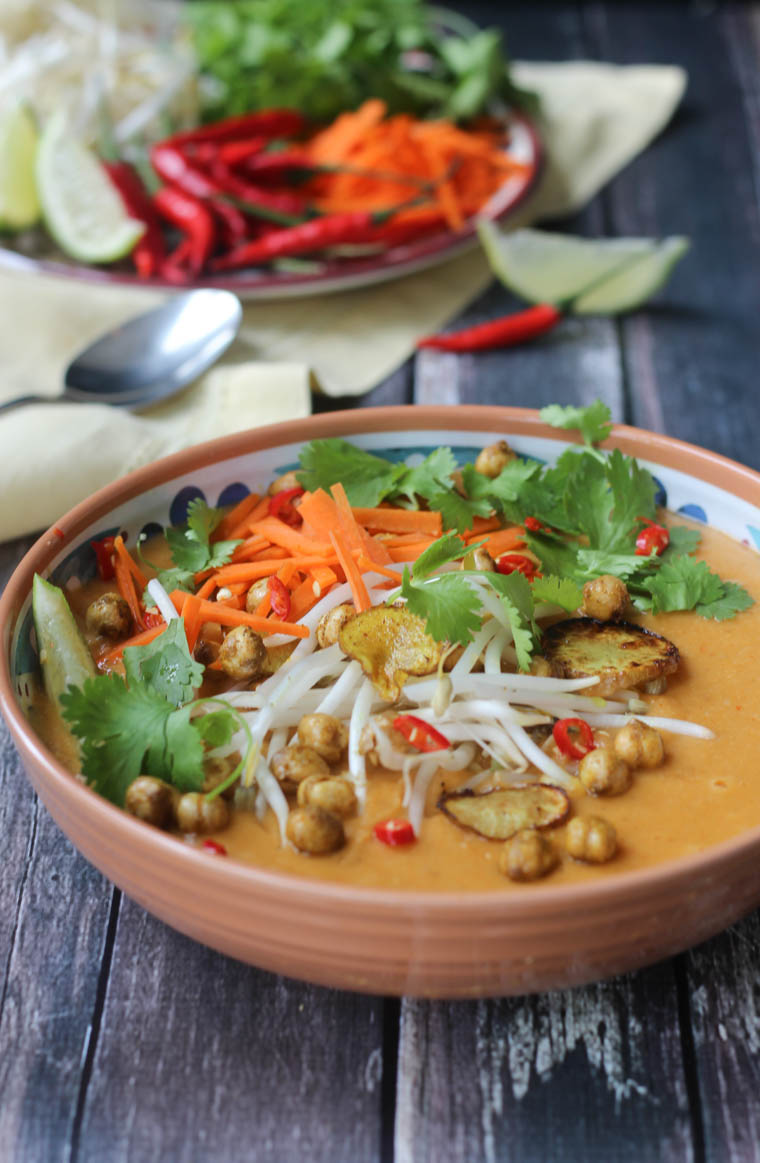 Close up of vegan curry soup with crispy chickpeas and sunchoke chips.