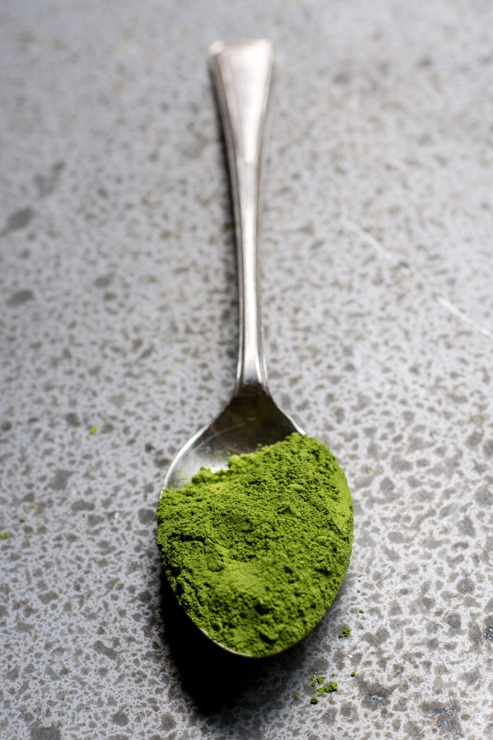 Spoon with green powder.