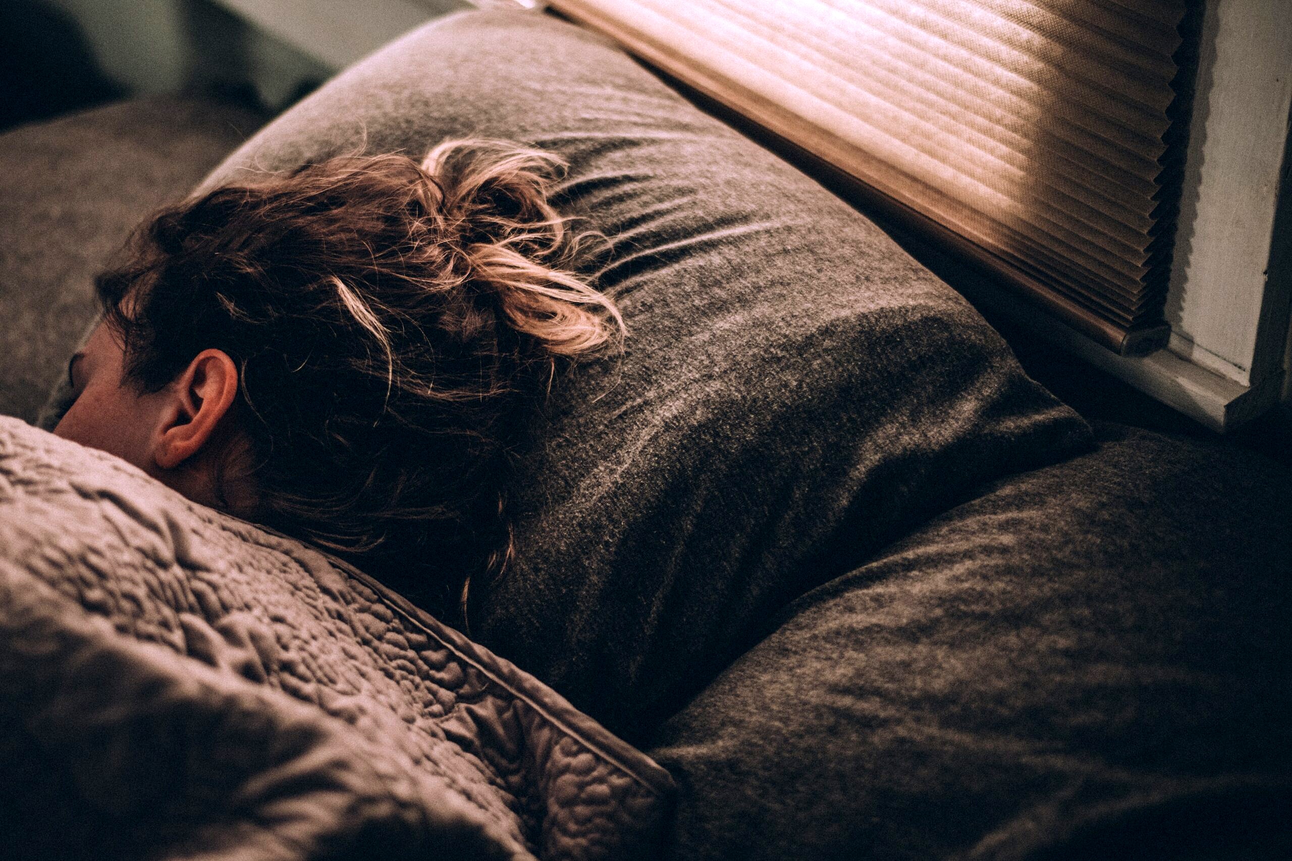 Person sleeping in a bed.