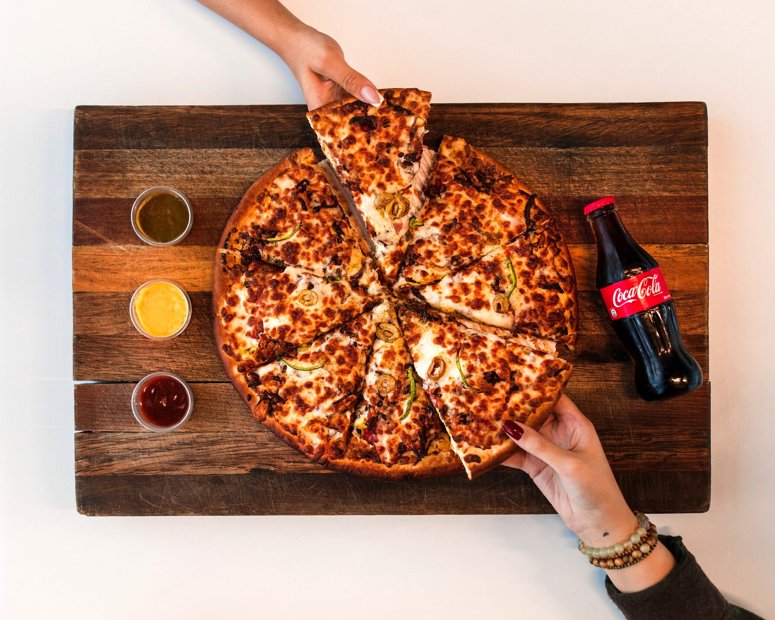 Birds eye view of a pizza being shared.