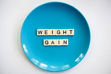 Blue plate with letters spelling "weight gain".