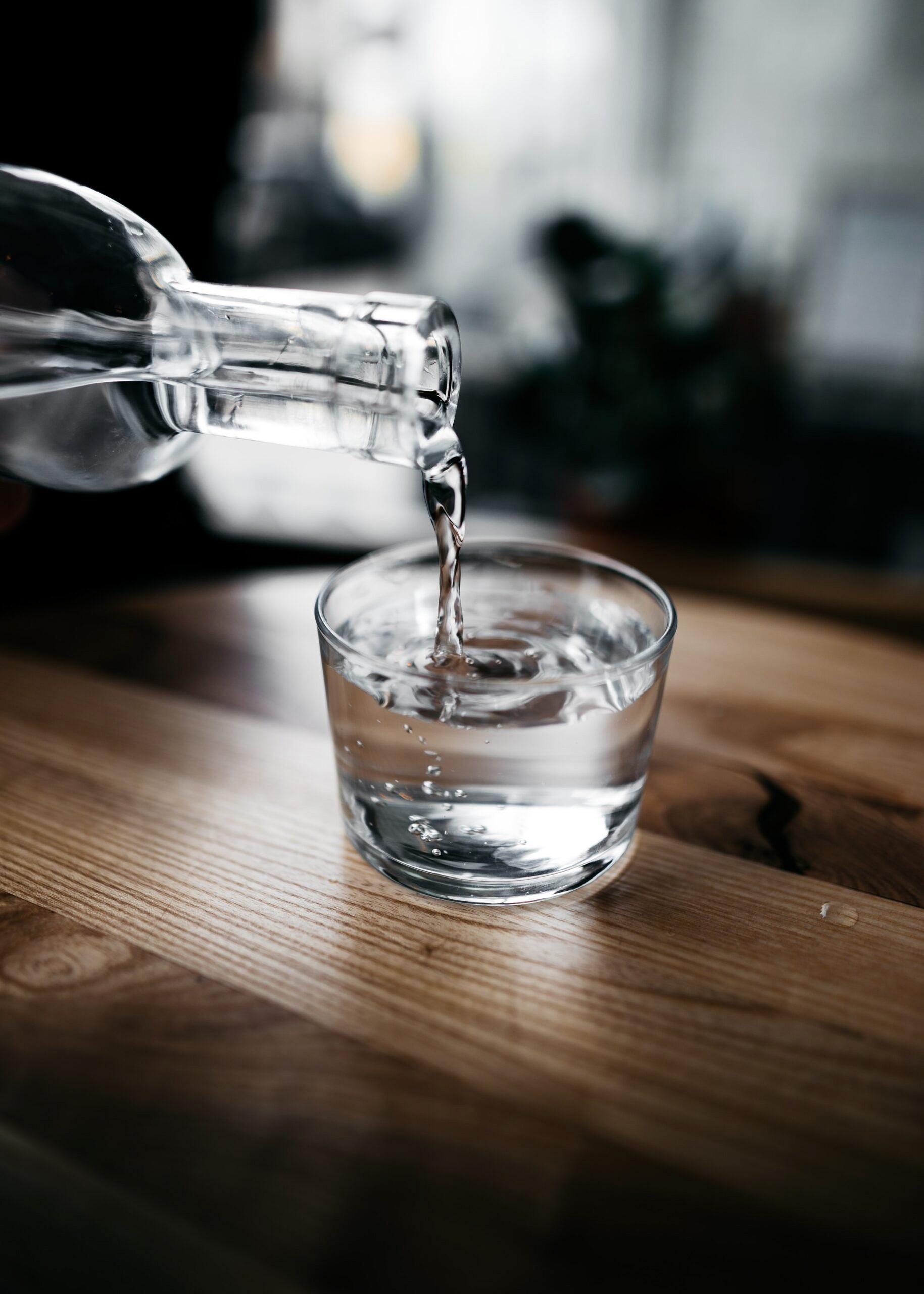 Close up of water being poured into a glass.