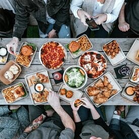 Birds eye view image of people eating around a table.