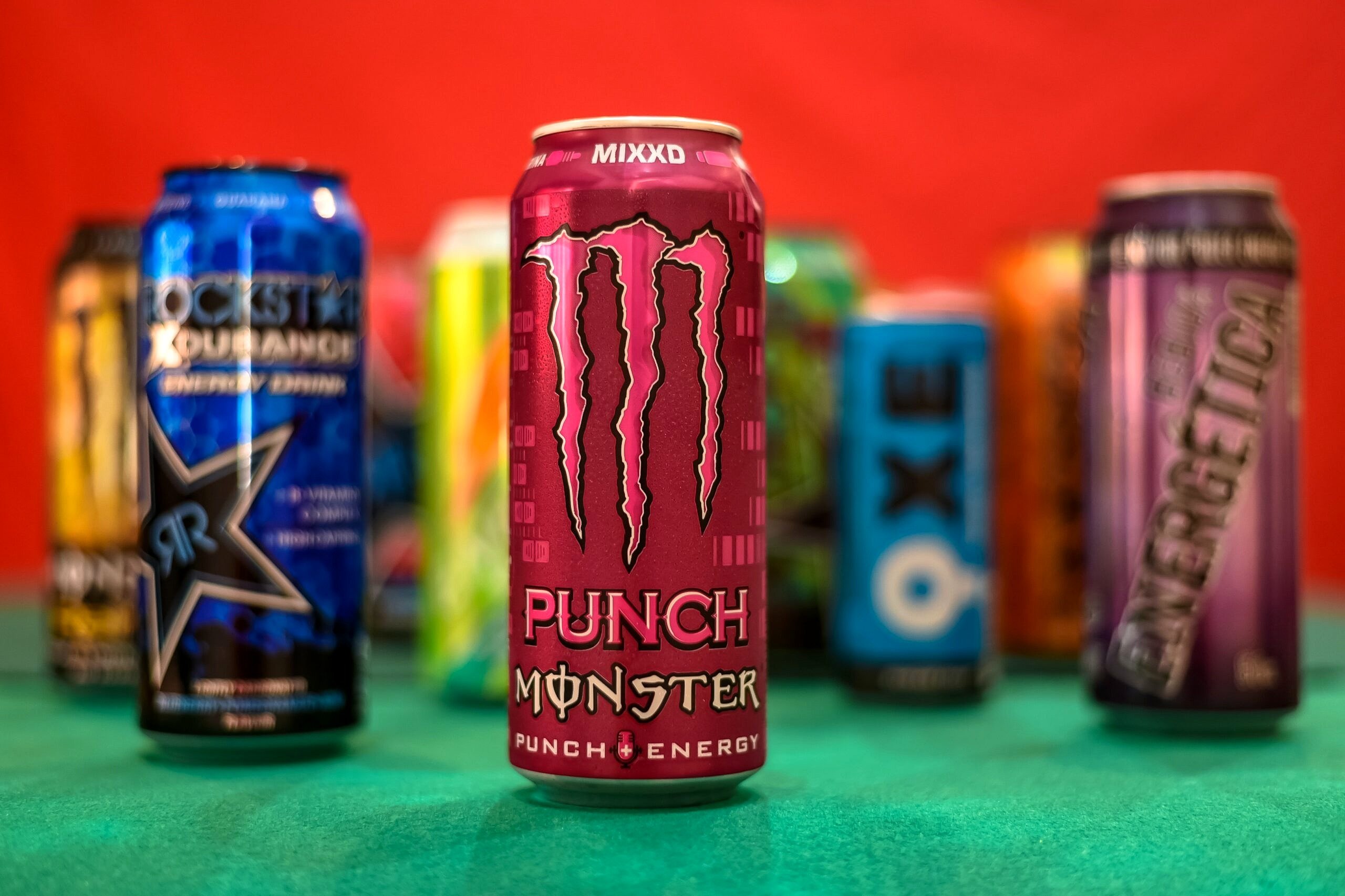 Energy drinks on a green table.