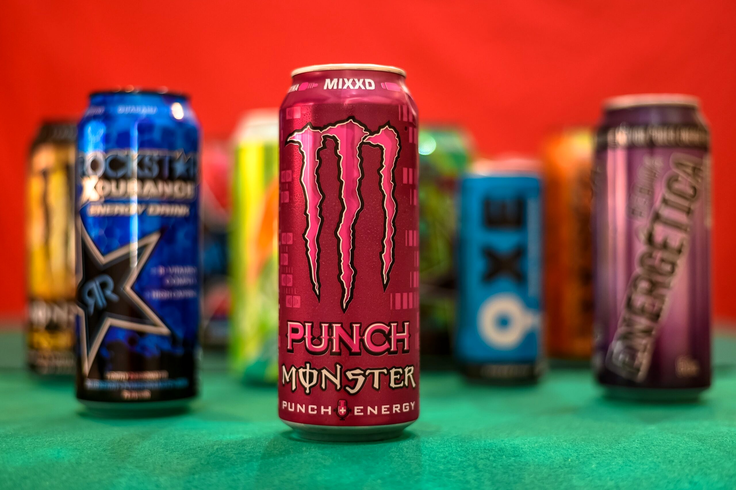 Energy drinks on a green table.