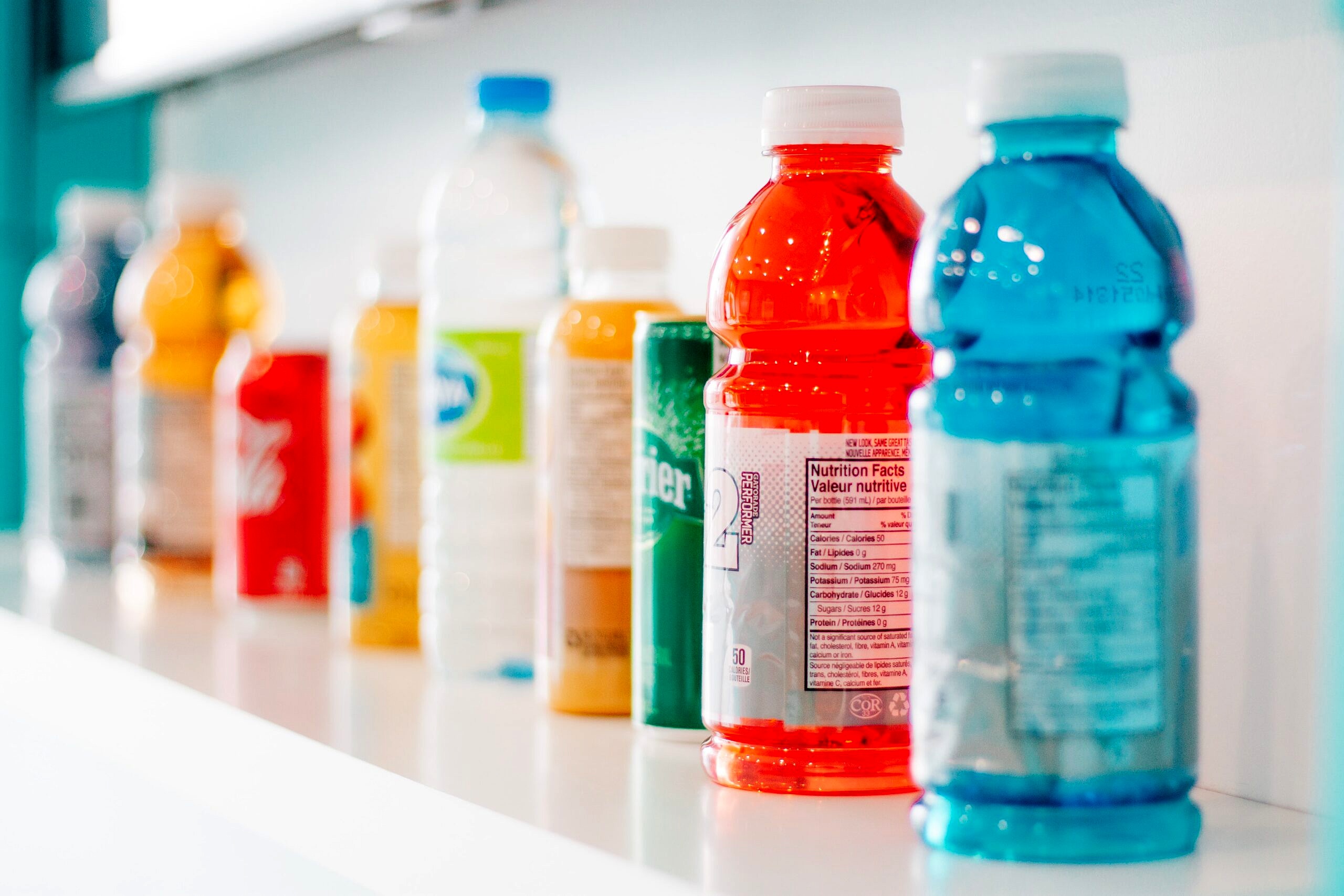 Row of drinks on a shelf to discuss sports & energy drinks.