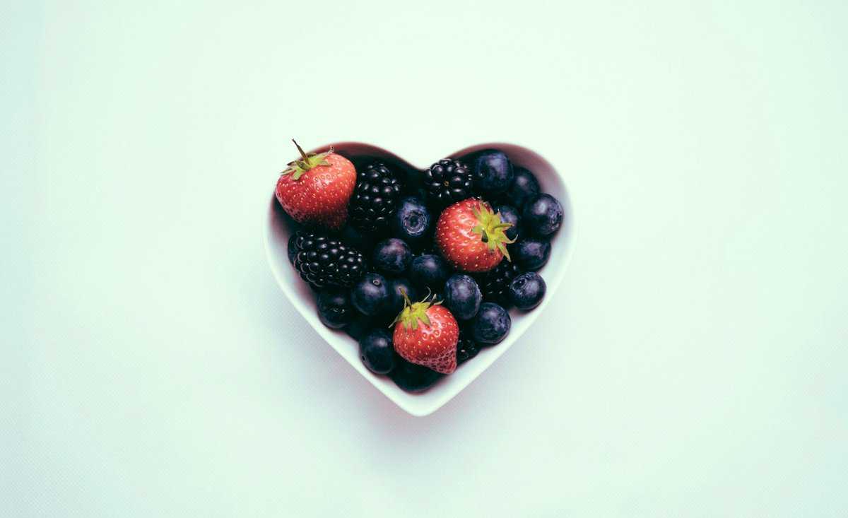 Berries in a heart-shaped bowl.