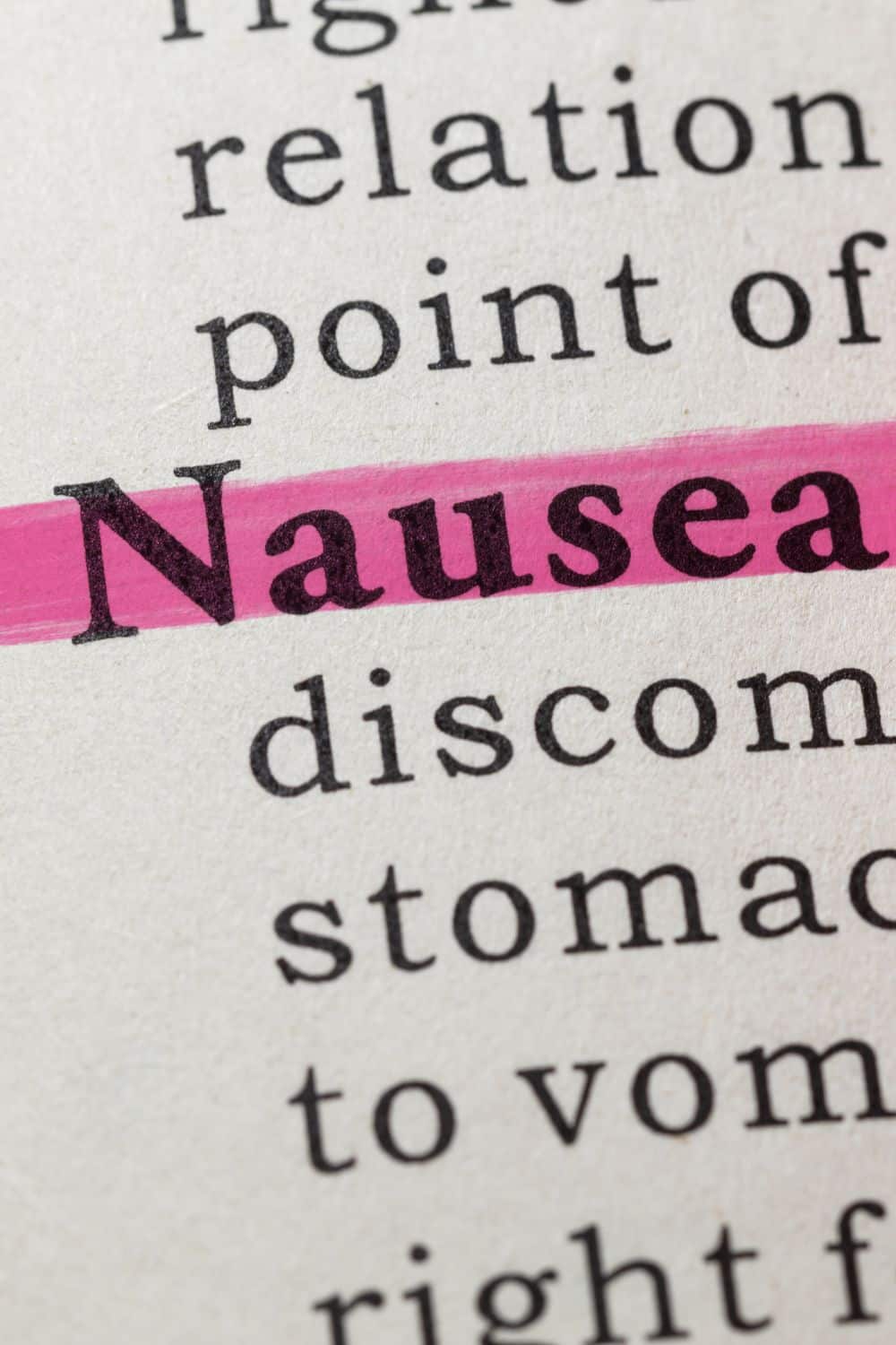 Highlighted pink text of the word "nausea" in a textbook