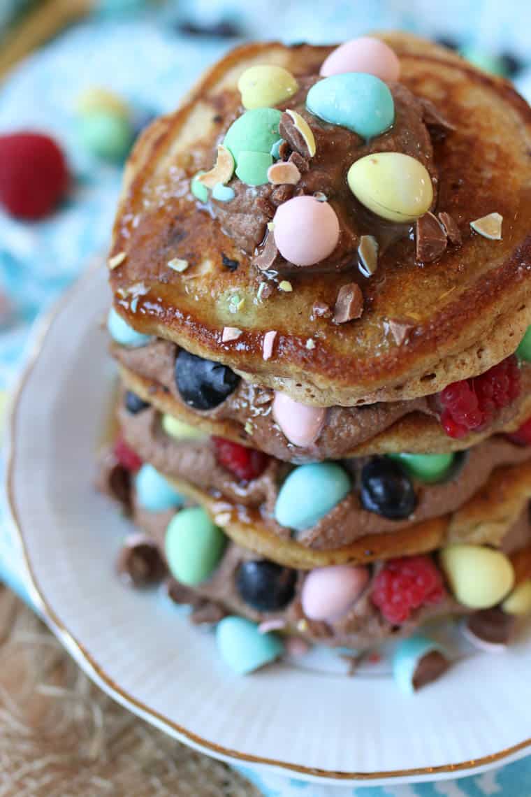 Close up of mini egg protein pancakes with chocolate mousse and berries.