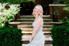 Abbey twirling in a light gray dress.