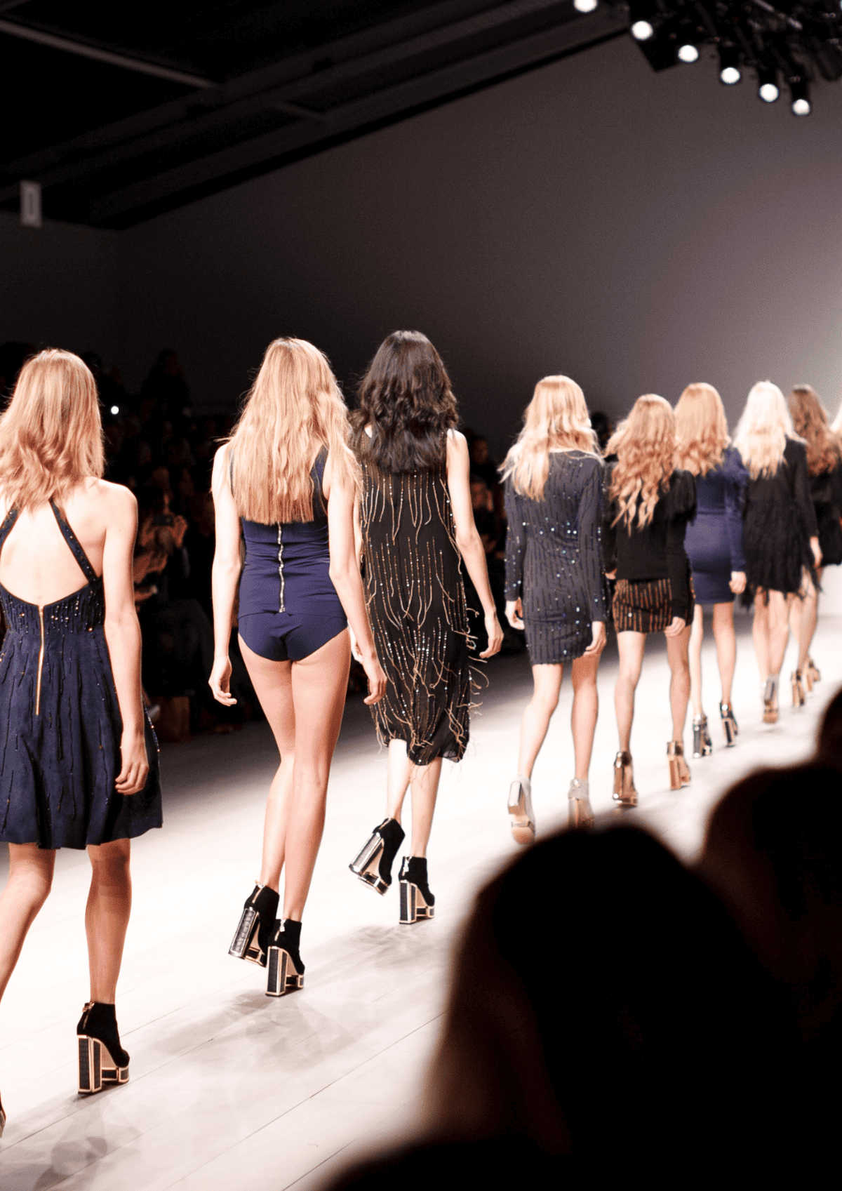 Victoria Secret models walking down a runway.
