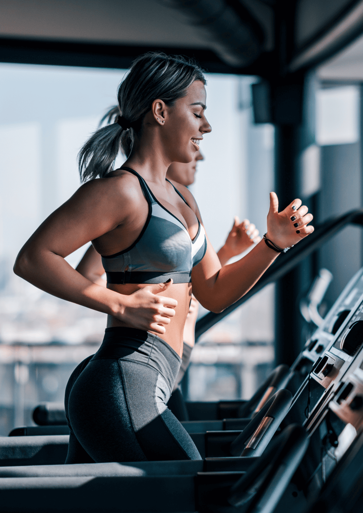 Woman running on a treadmill .