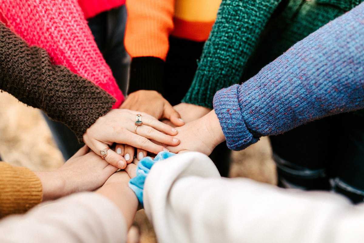 Piling hands in the middle to show solidarity.