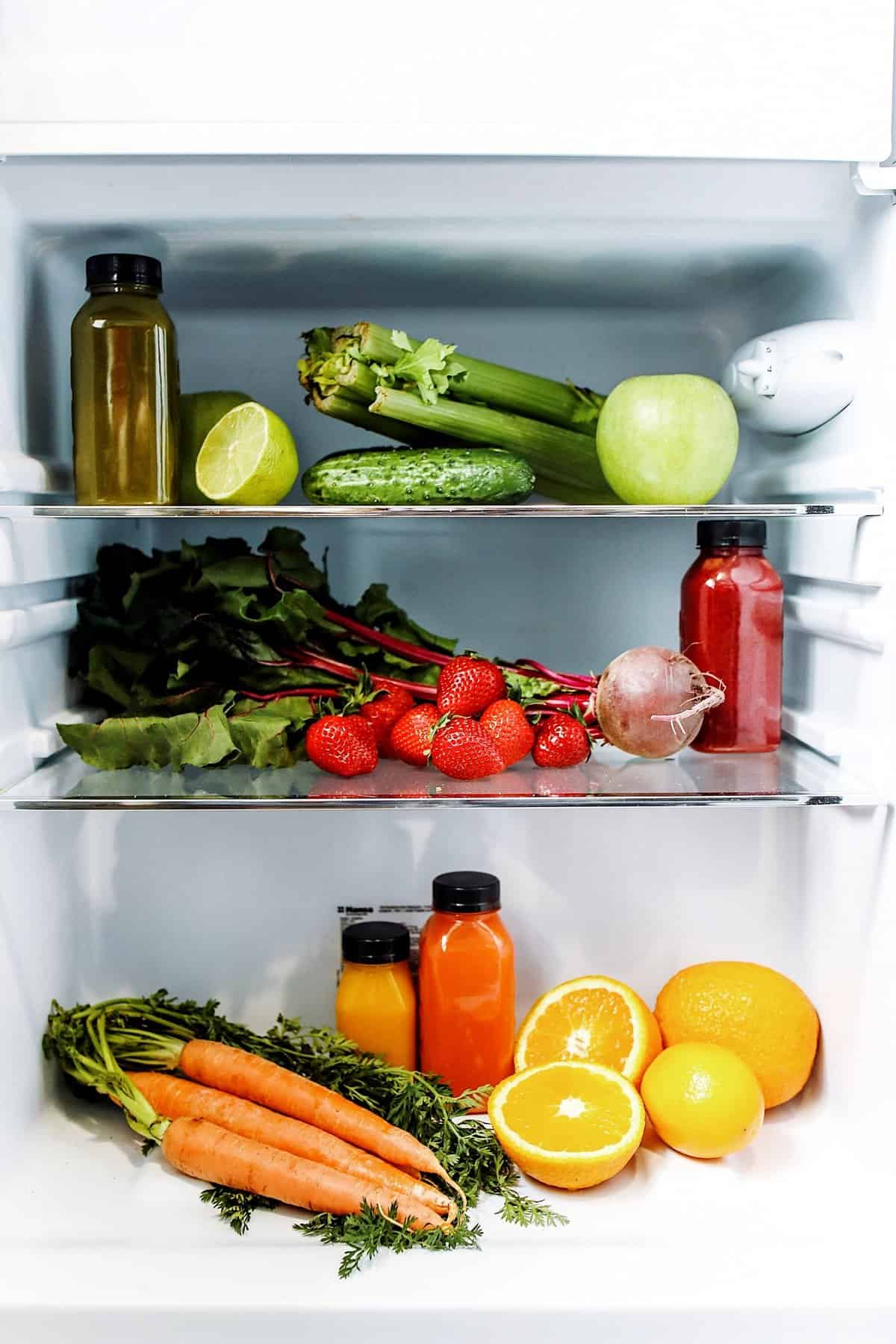 Fridge shelves stocked with healthy food, veggies and fruit in an ingredient household.