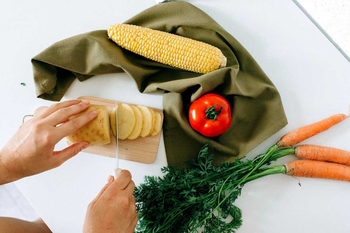 Cutting vegetables to batch prep meal building blocks.