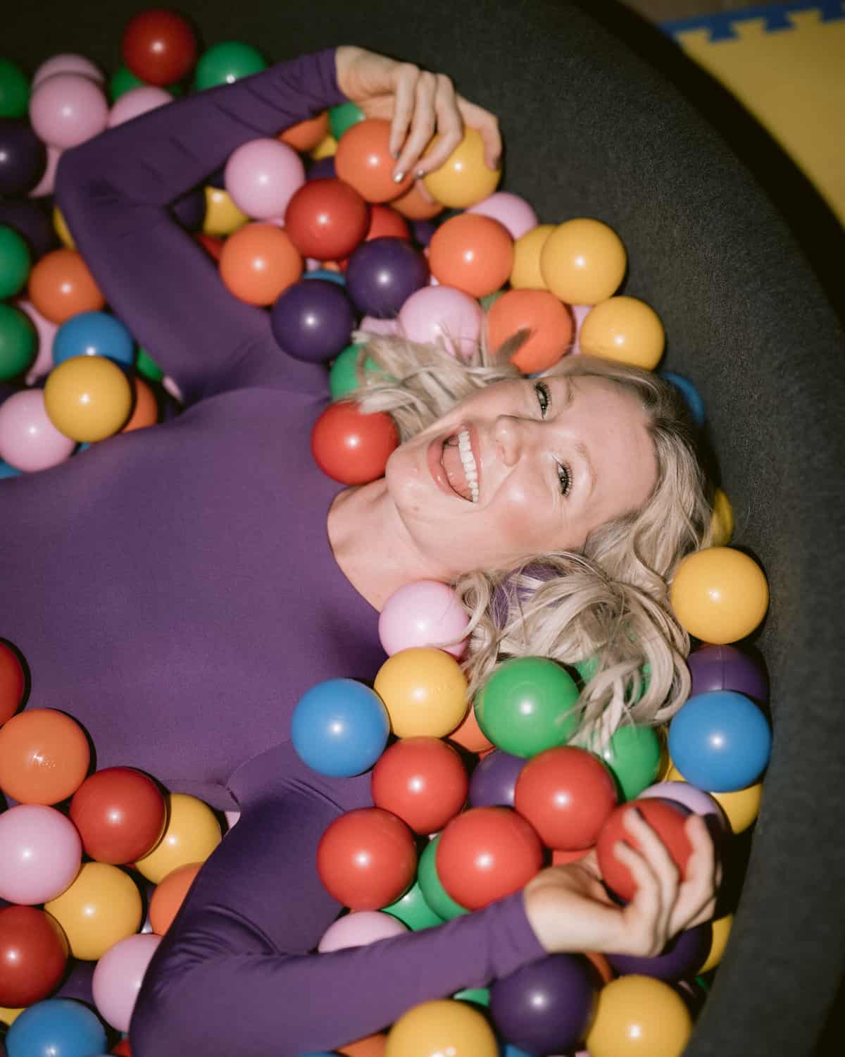 Abbey lying in a ball pit.