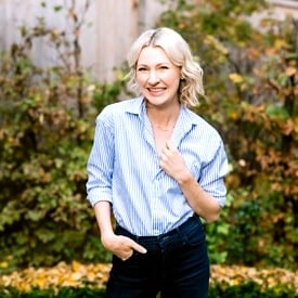 Abbey standing in a garden smiling.