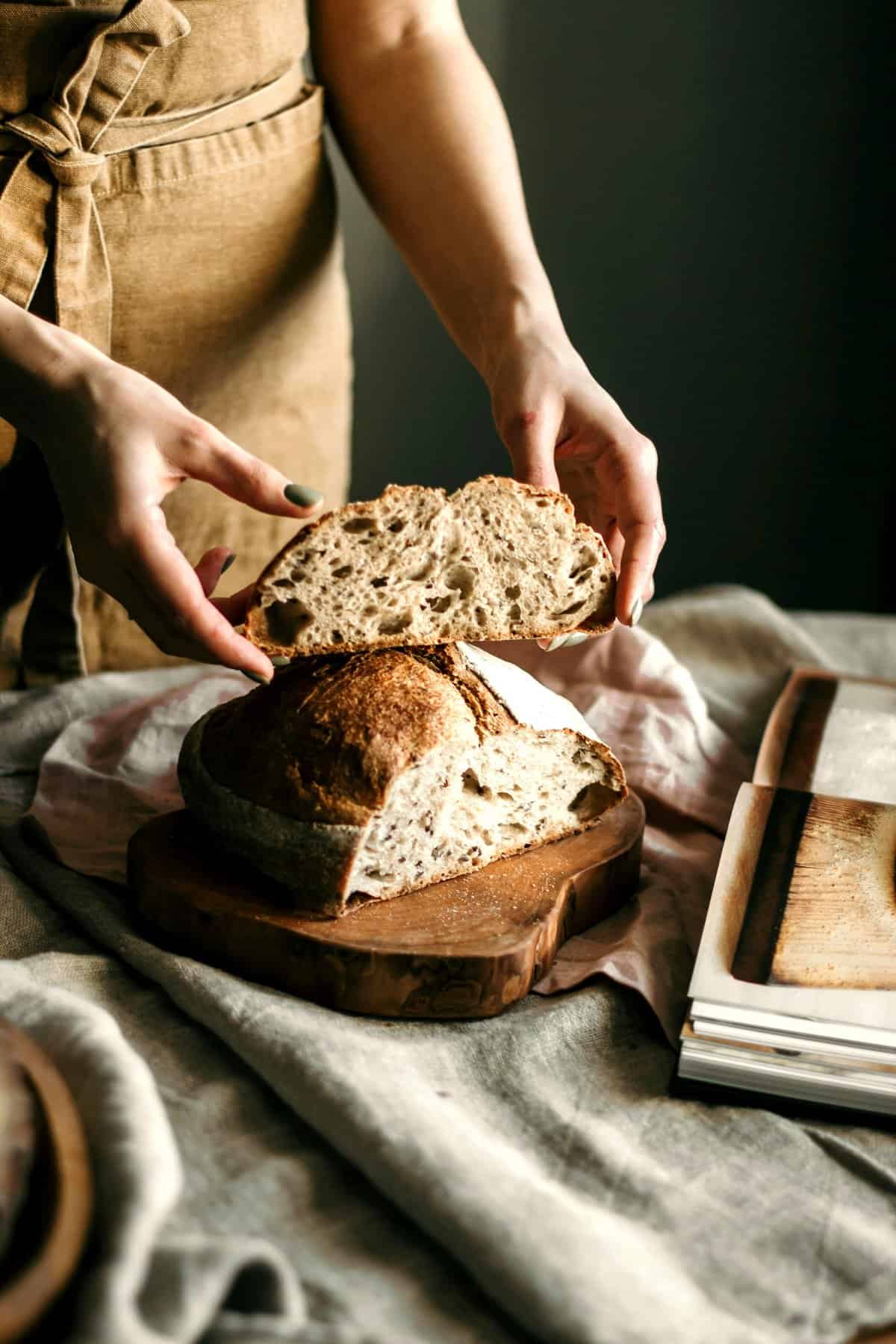Trad wife influencer holding sourdough bread.