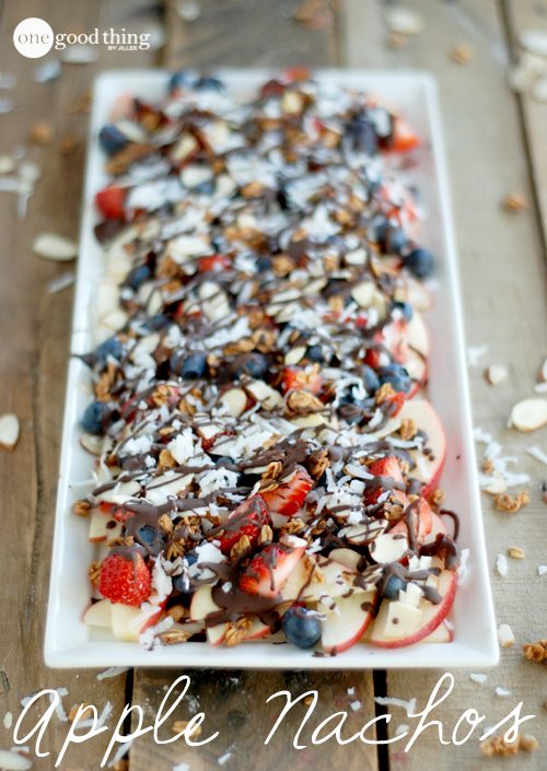 A long plate with apple nachos with chocolate drizzled on top.