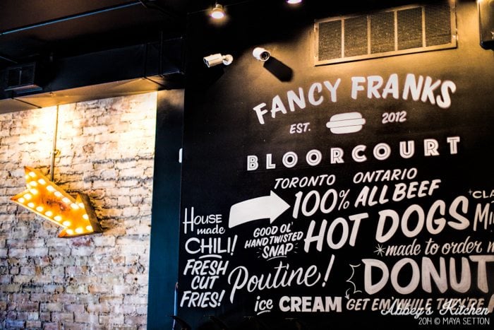 Fancy Frank\'s Gourmet Hot Dog\'s wall art and menu.
