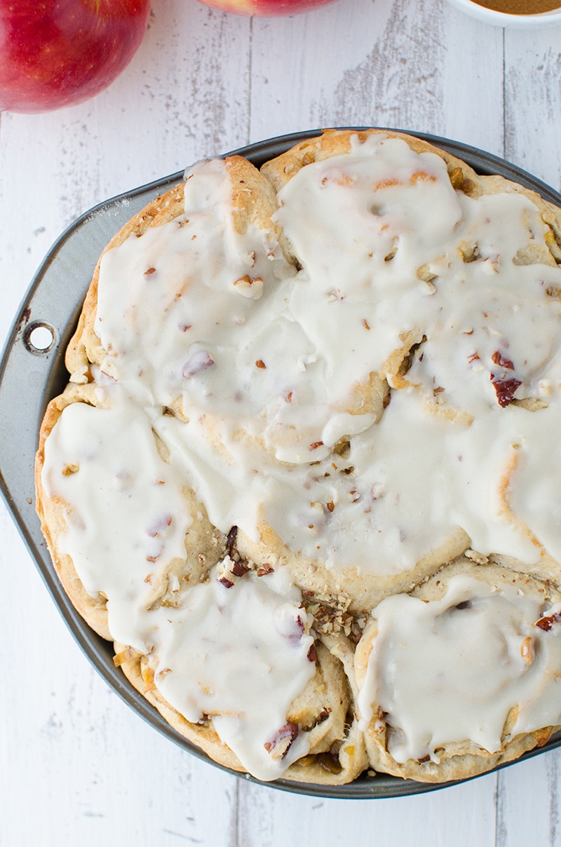 A baking dish with apple pie rolls.