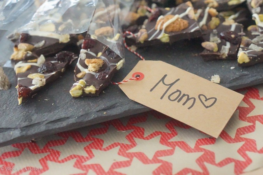 A bag of chocolate bark with a tag reading \"Mom.\"