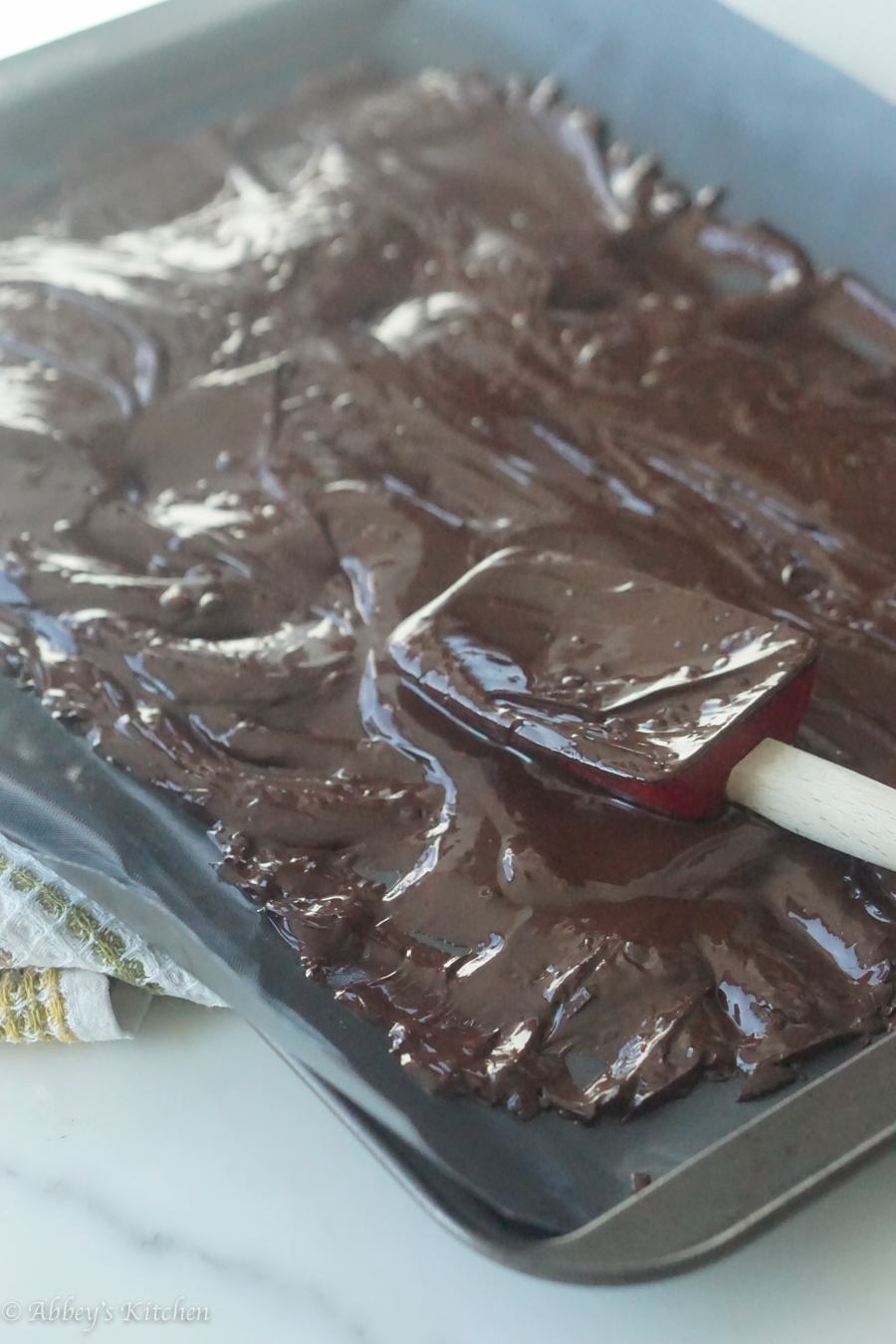 Chocolate being spread with a spatula. 