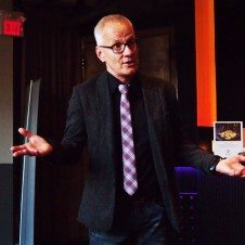 A person in a tie standing with his arms out.