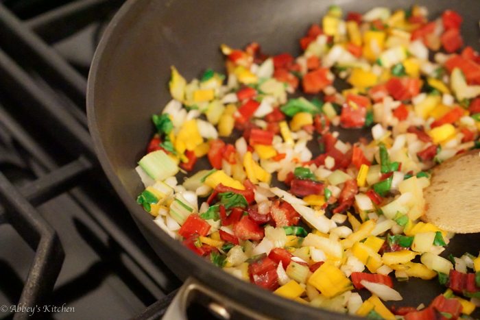 A skillet with vegetables.