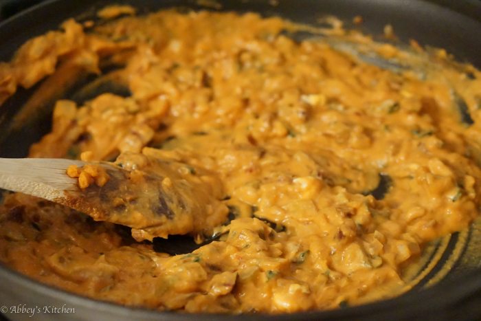 A pan making a sauce for pumpkin pasta.