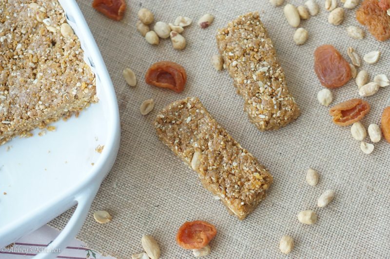 Overhead photo of two gluten free granola bars beside a white baking dish.