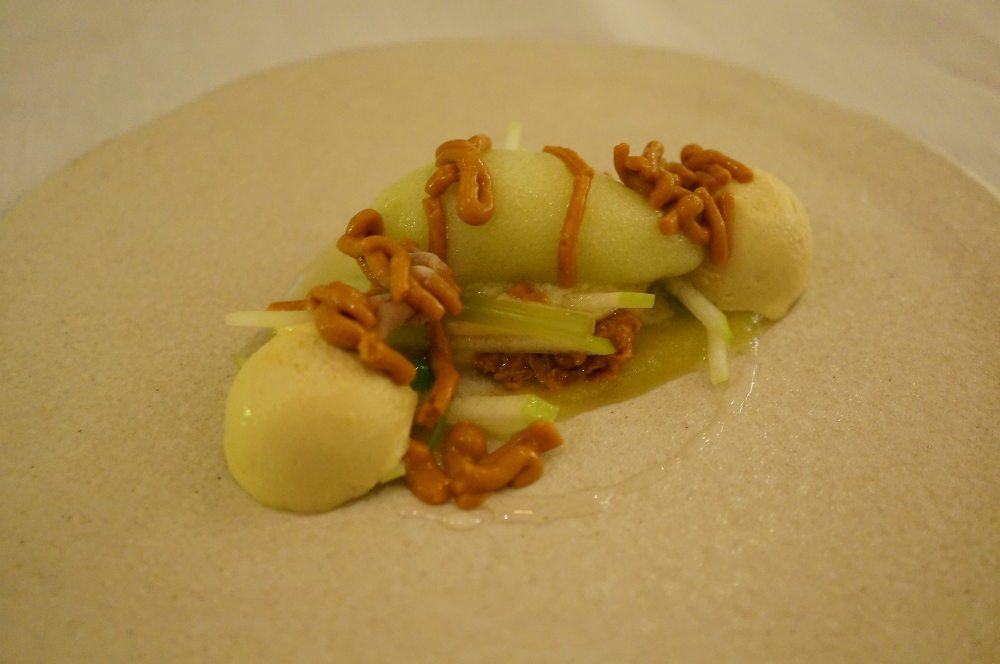 A plate of peanut cream, green apple and yuzu puree.